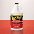 Bottle of EZ Stain concrete stain on a red surface with a white background